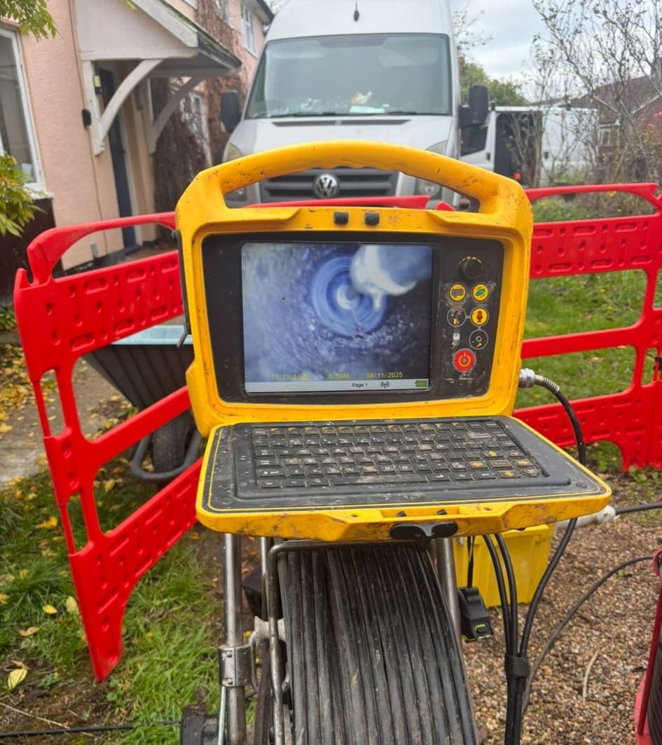 Drainage engineer using camera to inspect external drain for root intrusion