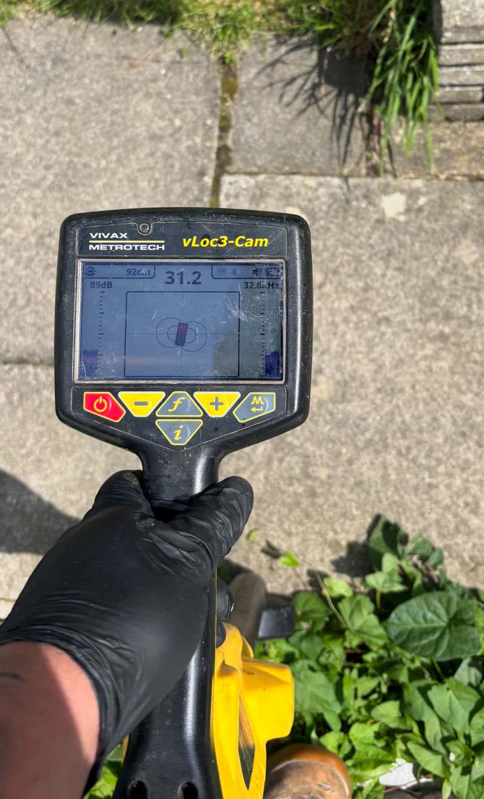 Drainage engineer using a sonde device to trace drainage pipe routes, depths and connection points