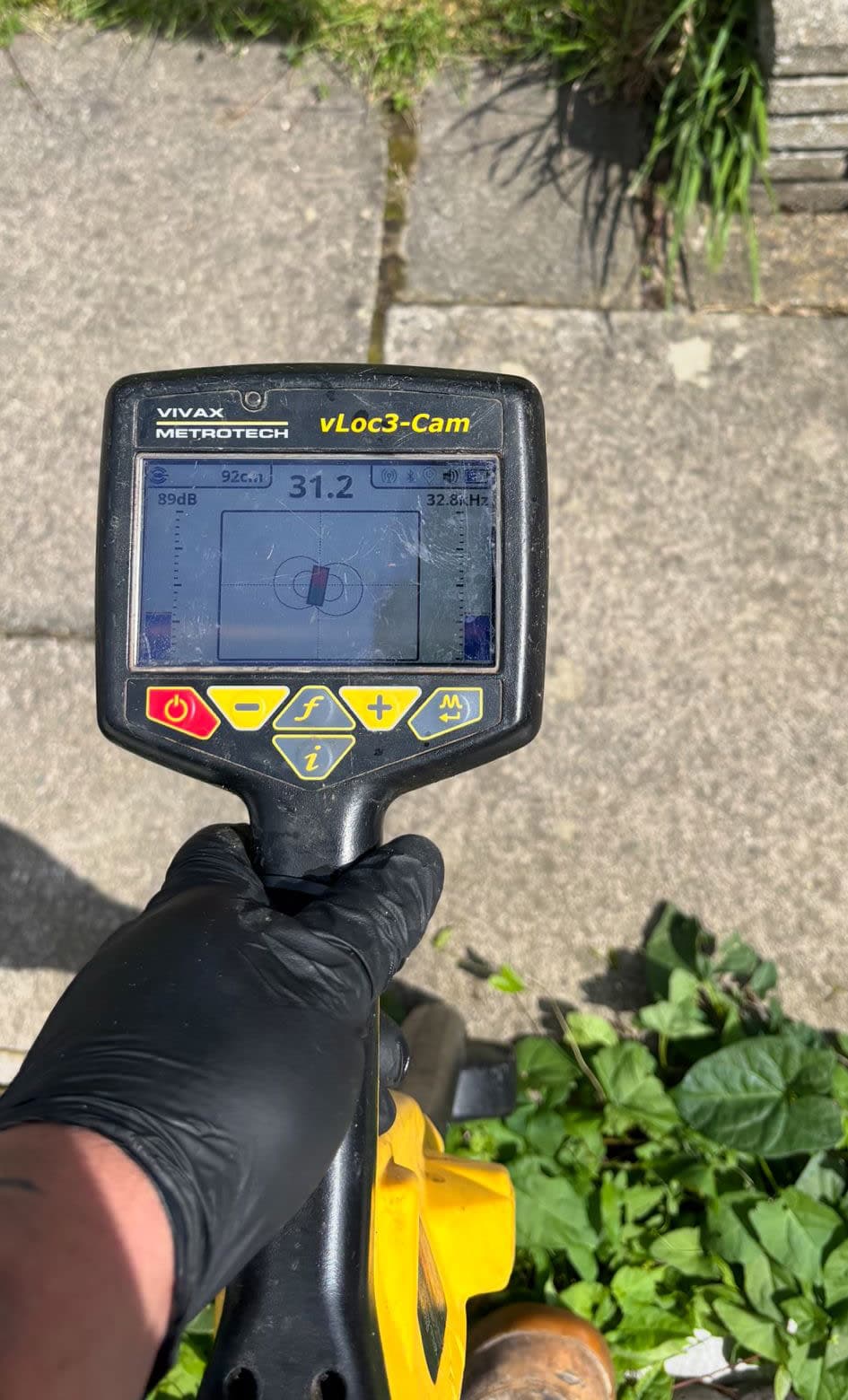 Drainage engineer using a sonde device to trace drainage pipe routes, depths and connection points