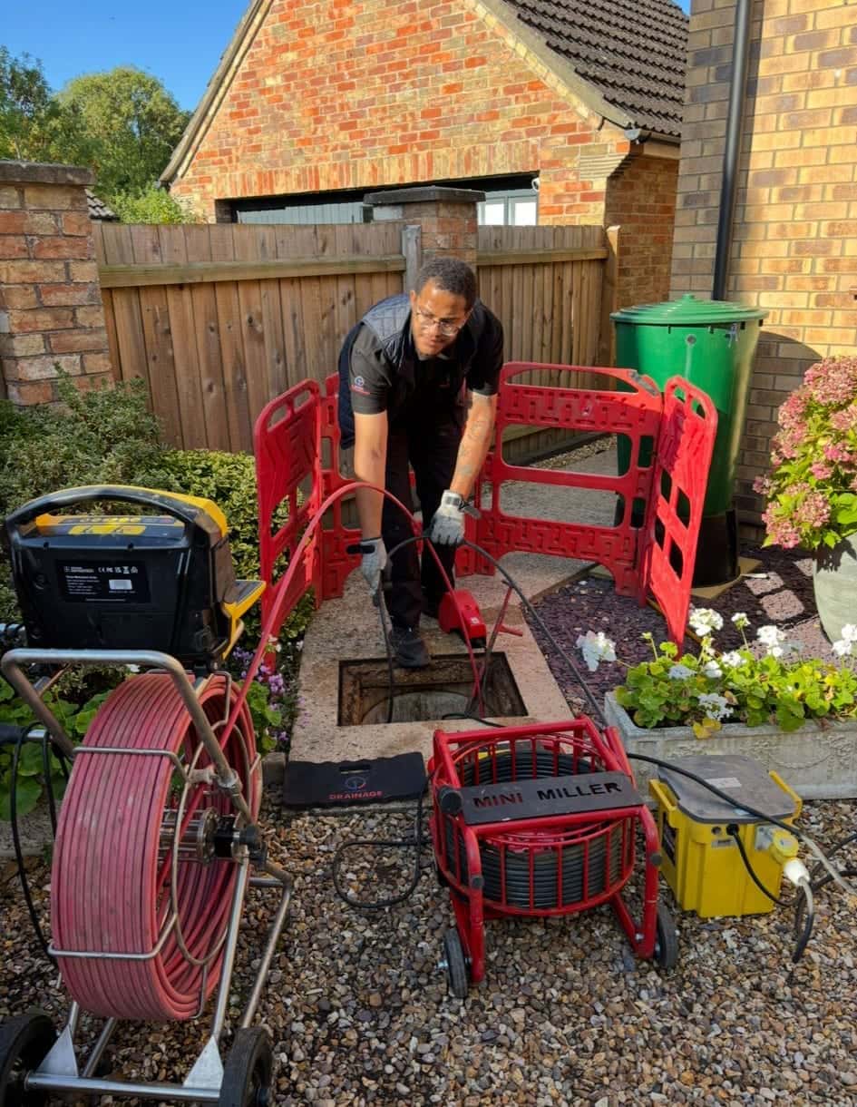 Drainage engineer preparing to complete high pressure water jetting on an external drain
