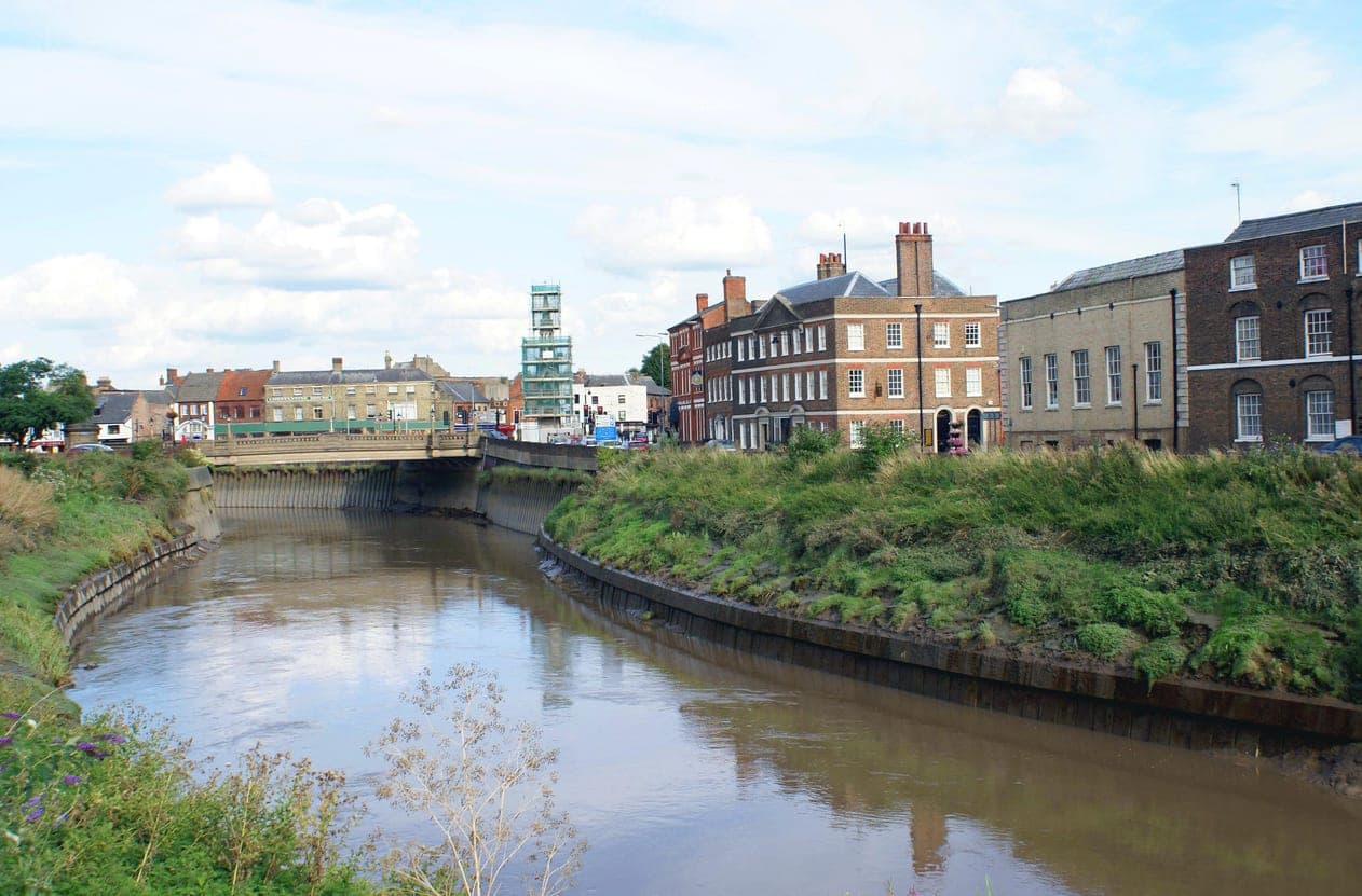 A view overlooking the river flowing through Wisbech in Cambridgeshire showing the location where 1st Response Drainage provides drainage services